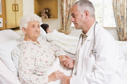 Doctor Talking With Senior Woman Patient In Hospital