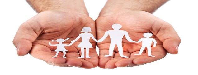 Cardboard figures of the family on a white background. The symbol of unity and happiness. Hands gently hug the family.